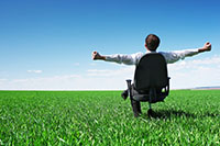 Image of man sitting on huge green lawn